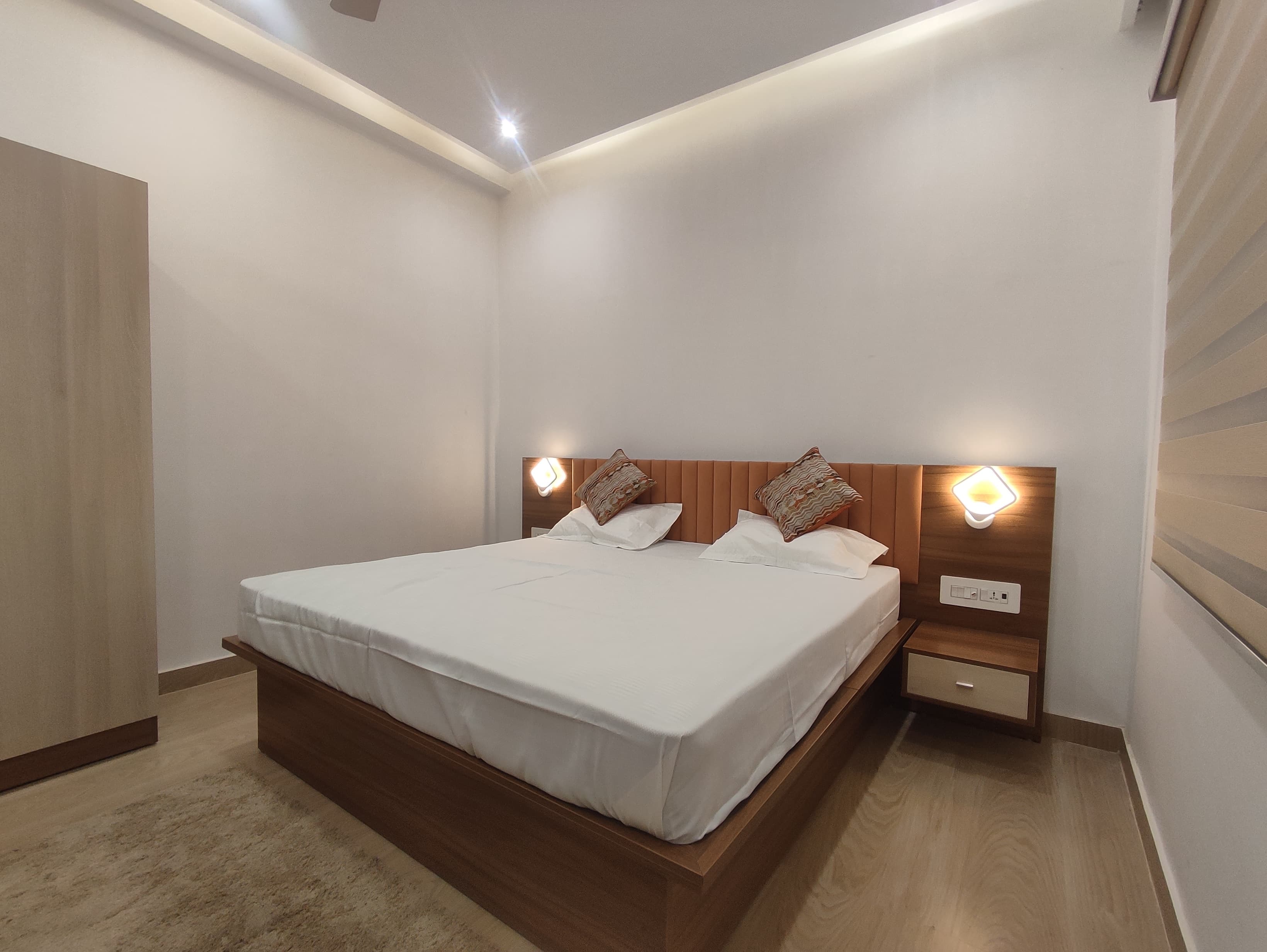A clean, air-conditioned deluxe bedroom at The Tribhuvan Residency